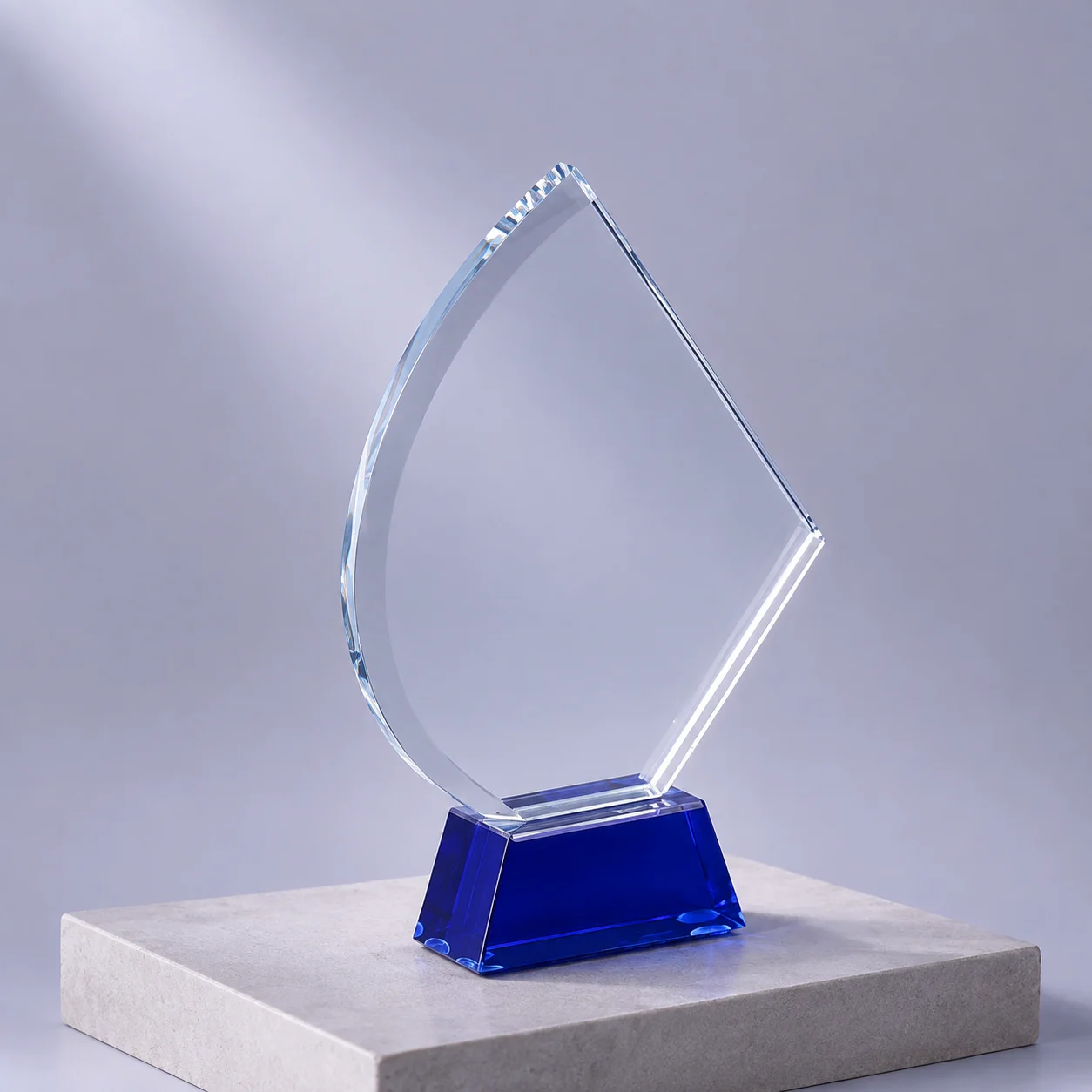 Close-up of a polished crystal award with a deep blue base